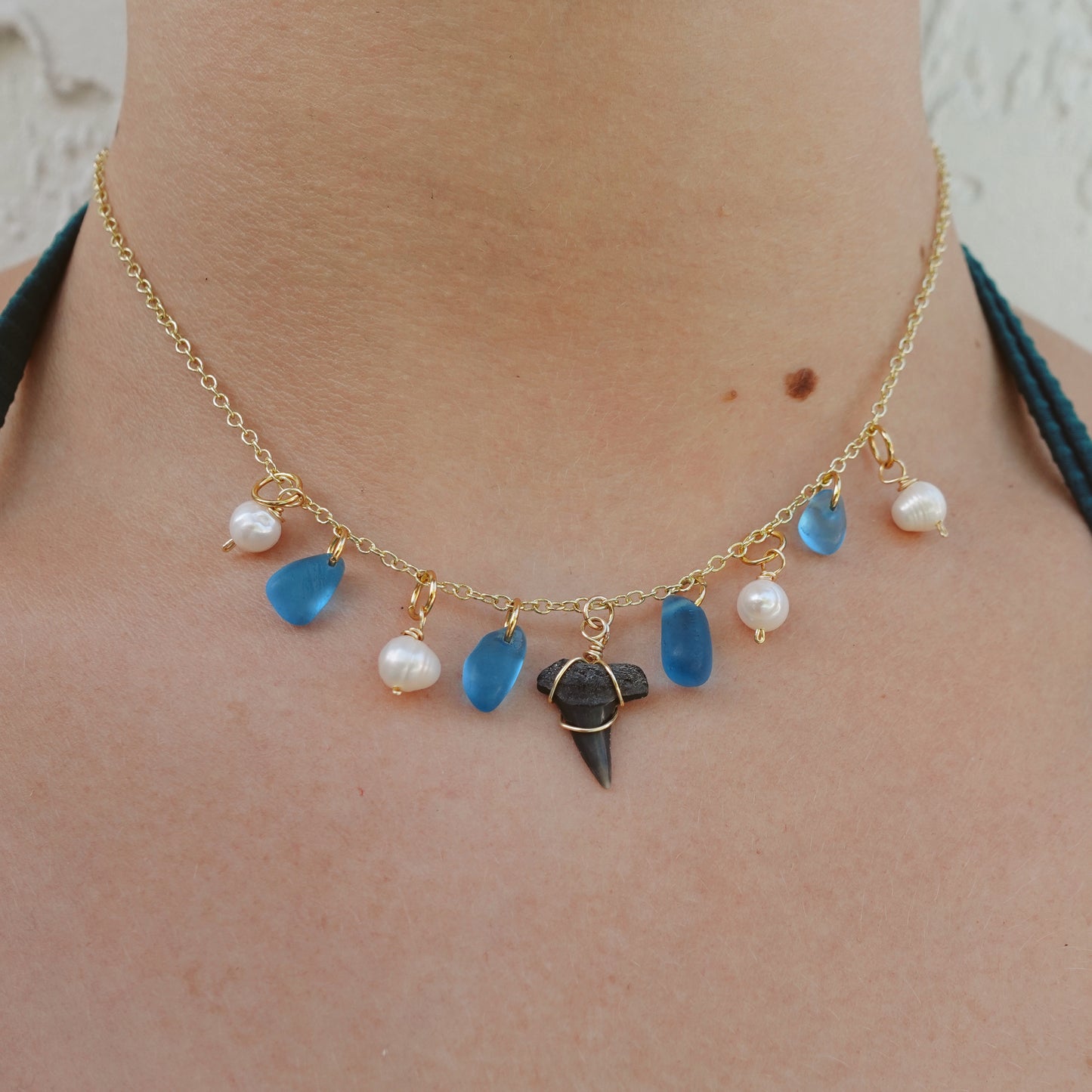 fossil tooth and glass charm necklace